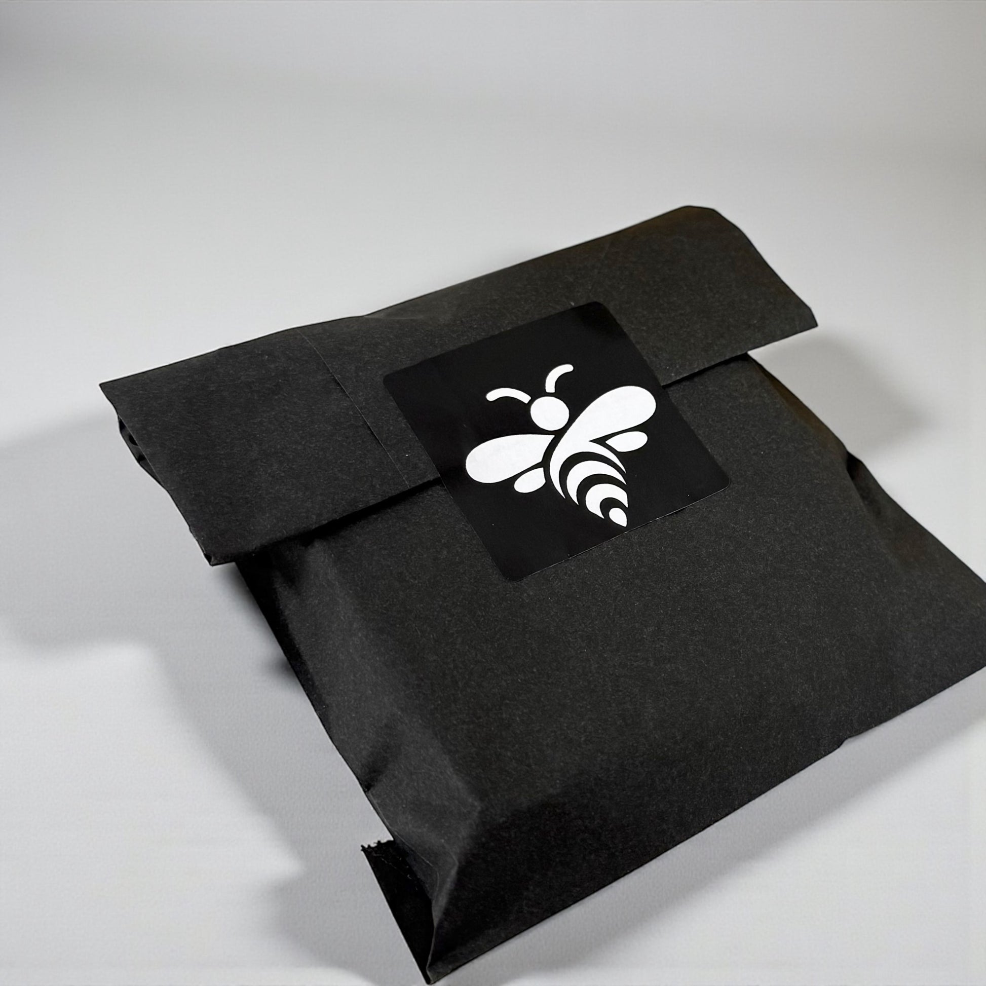 Black envelope with a white bee logo on a light gray background