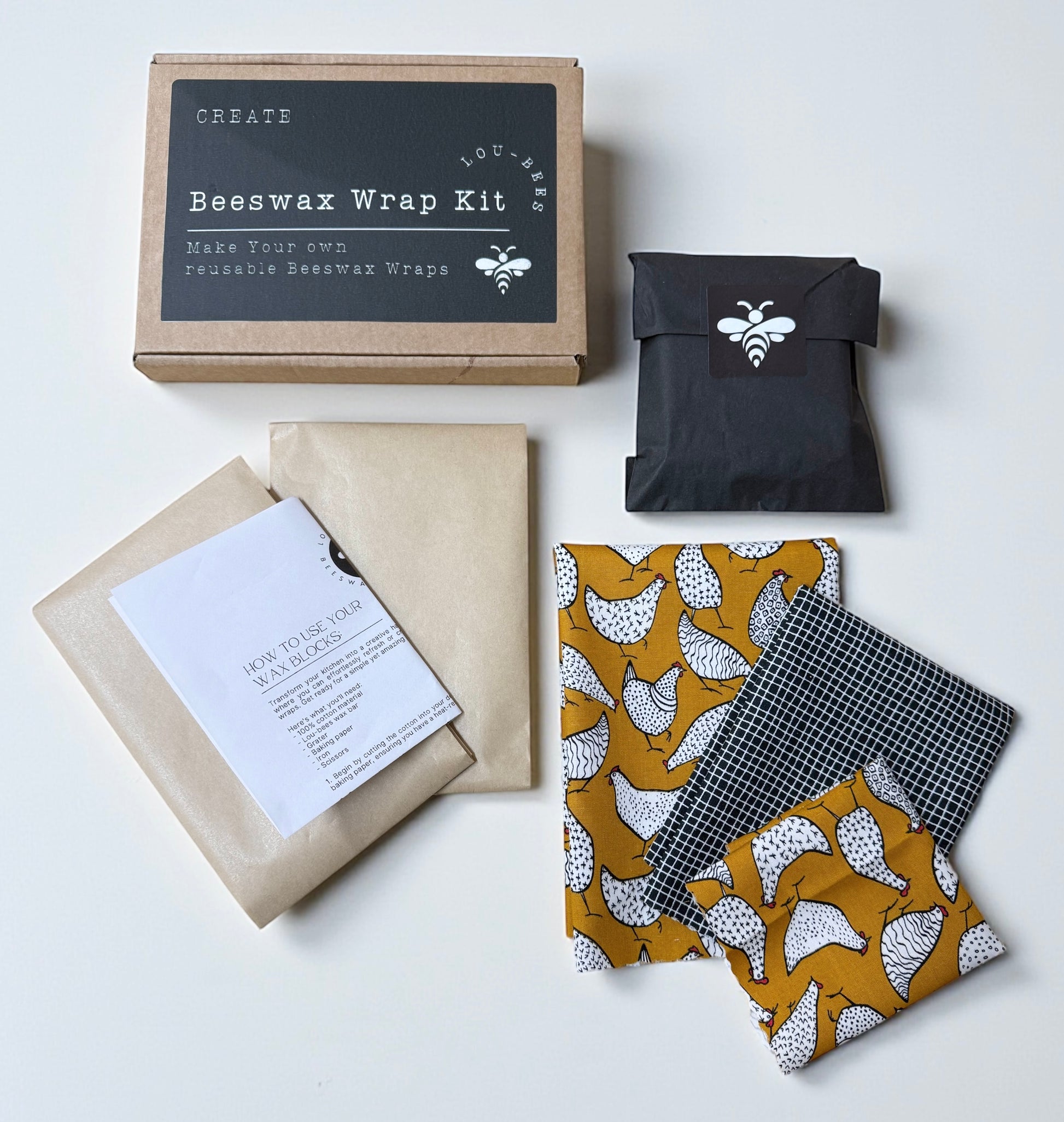 Beeswax wrap kit with packaging and wrapped items on a white background